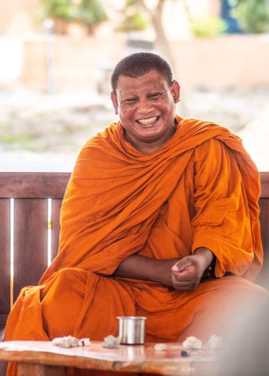 Smiling Buddhist monk leading an Inner Walk session at Wonderland Healing Center