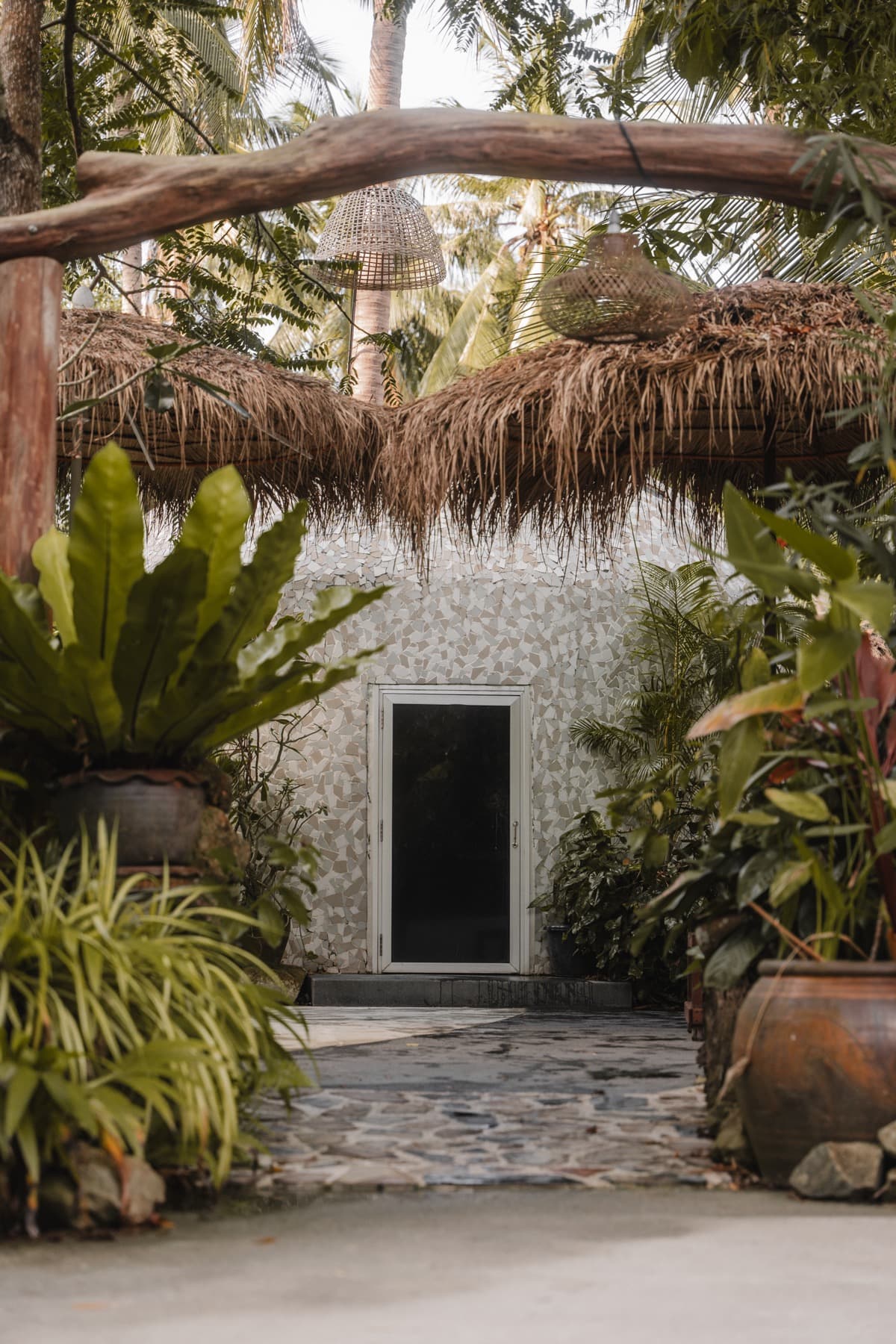 The dome-shaped herbal steam sauna surrounded by lush plants